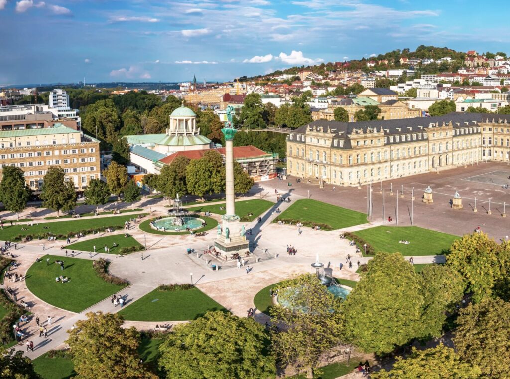 Luftaufnahme des Schlossplatzes in Stuttgart mit Brunnen, Gr&uuml;nfl&auml;chen und historischen Geb&auml;uden.